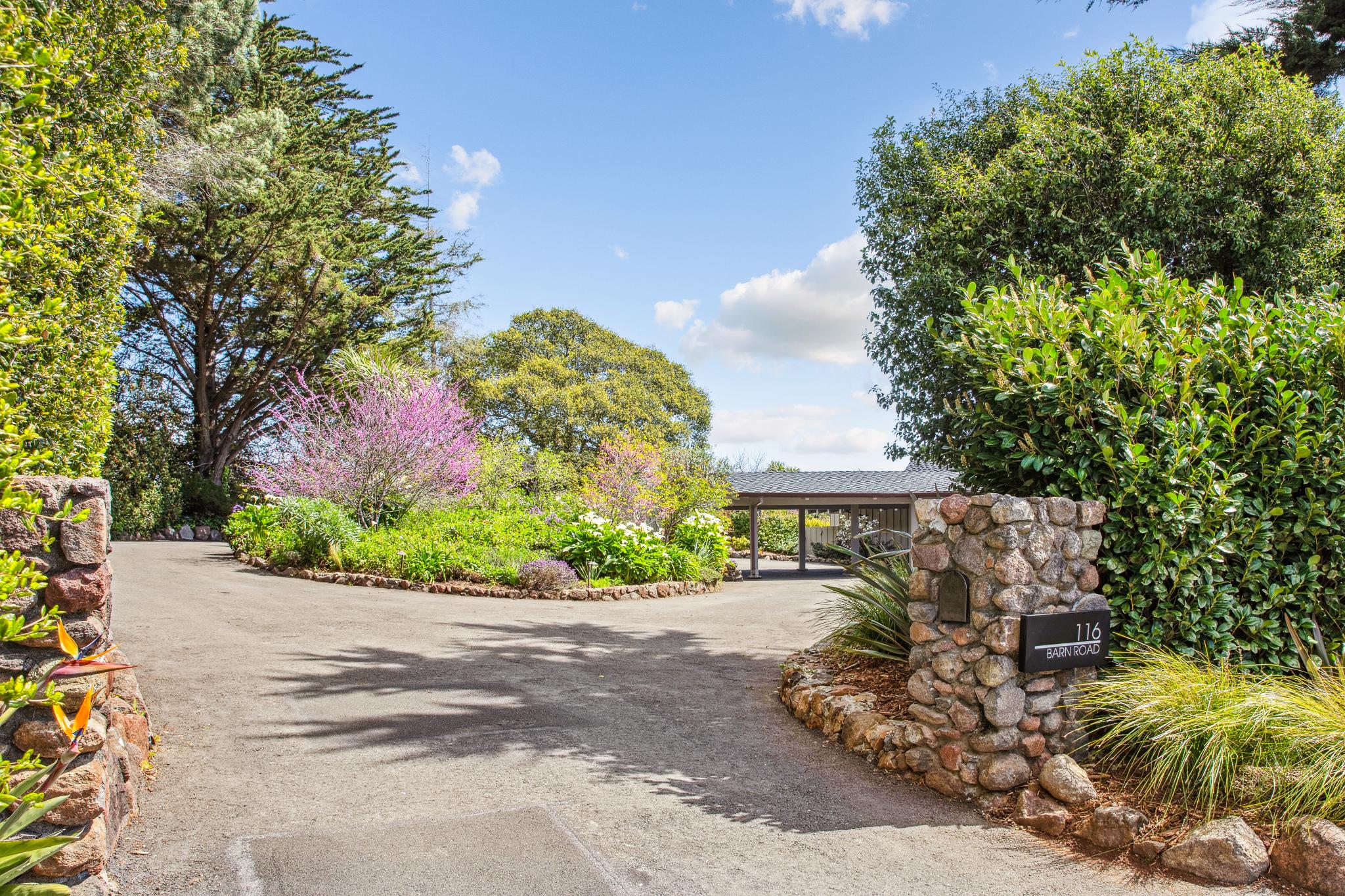 Landscaped entrance with stone pillars at 116 Barn Road