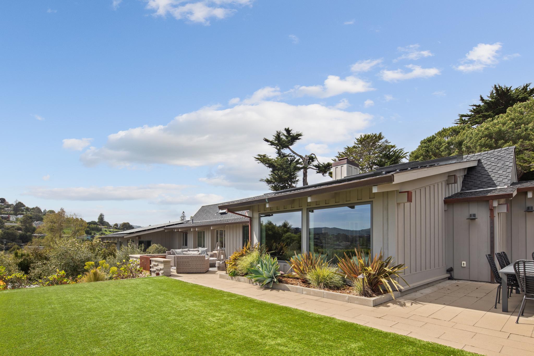 Barn Road home overlooking a landscaped lawn and garden